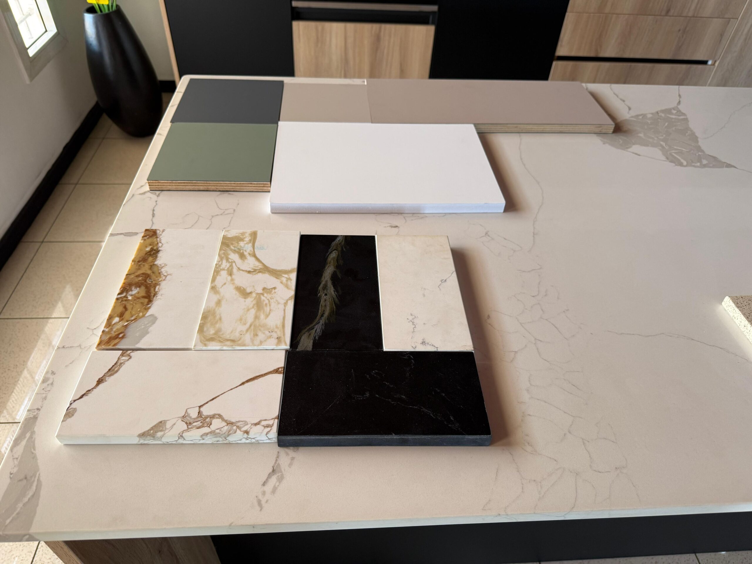 Kitchen materials used by Melamine World, the leading kitchen designers in Mauritius, including PVC plywood samples, Melamine plywood samples, and some quartz countertop samples