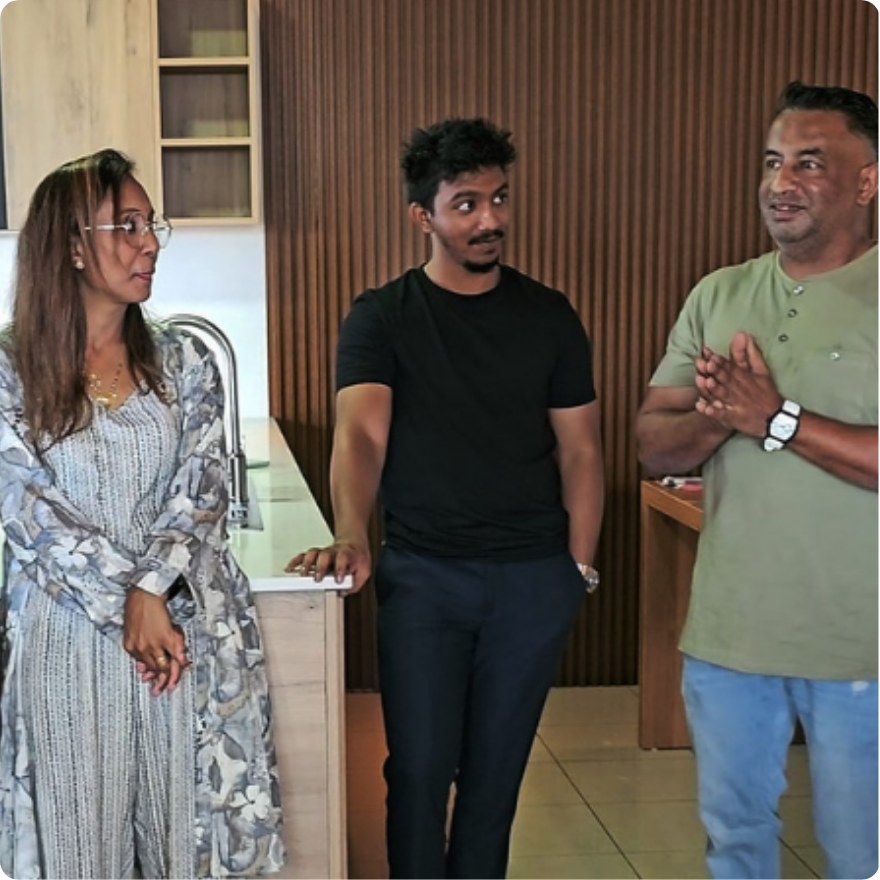 A family picture of the Hanrazsing family who runs the leading kitchen design company in Mauritius, standing and listening to a speech by the founder of the company, Mr. Rishi Hanrazsing.